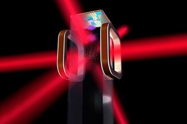 Magneto optical trap with red lasers shining through a clear cube holding molecules