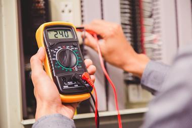 A photo of an engineer using a voltmeter