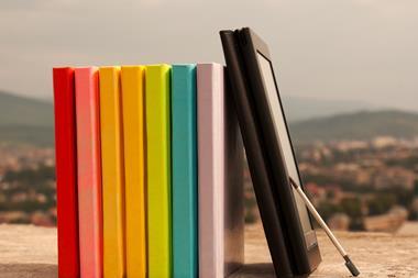 An image showing a row of books and an ebook
