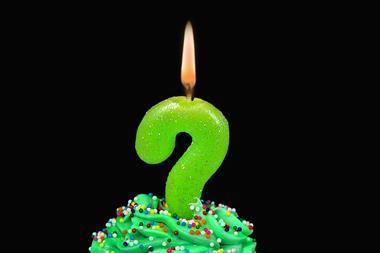 An image showing a birthday candle shaped as a question mark