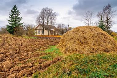 Autumn plowed fields farm house