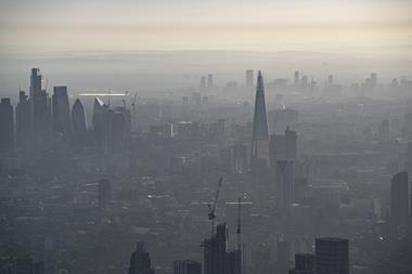 An aerial photo of a very hazy central London near sunset