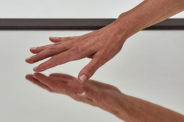 An image showing a hand touching a surface