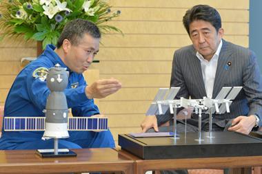 A photo of former Japanese prime minister speaking with Astronaut Koichi Wakata