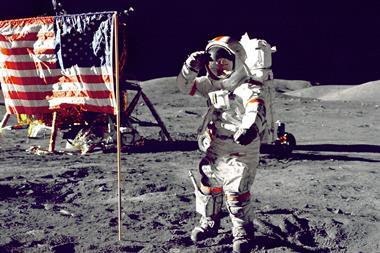 An astronaut on the moon saluting an American flag