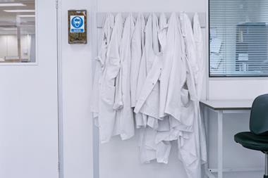 An image showing lab coats on hooks