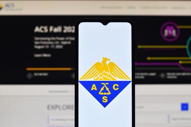 A mobile phone with the ACS logo in front of a computer with the ACS Fall website