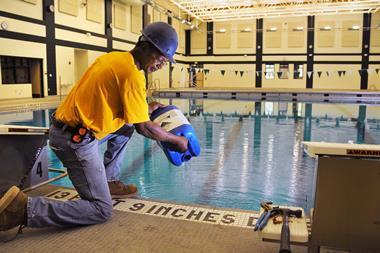 Man adding chlorine to a pool