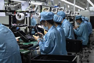 Working assembling mobile phones in a Chinese factory.