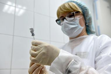 A photo of a medical worker preparing a syringe