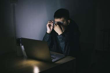 Man using laptop at night