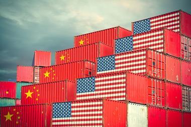 Chinese and United States cargo containers painted with their national flags sitting side by side