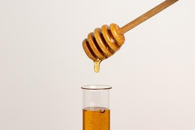Honey dripping into a test tube