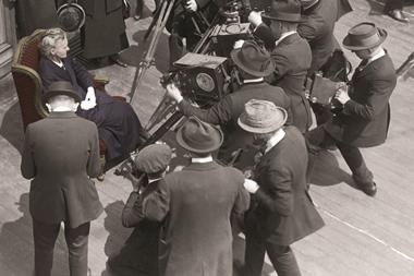 Marie Curie (circa 1915) with a group of cameramen on board a ship