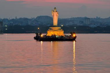 Buddha statue at dusk in Hussain Sagar in Hyderabad, India.