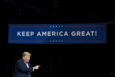 An image showing Donald Trump next to a Keep America Great banner
