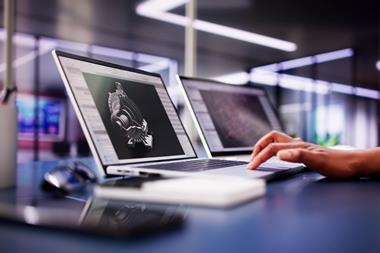 A person using professional CAD software on a laptop with their hand on the keyboard