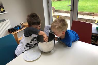 An image showing Neil's cute kids mixing the batter for a cake