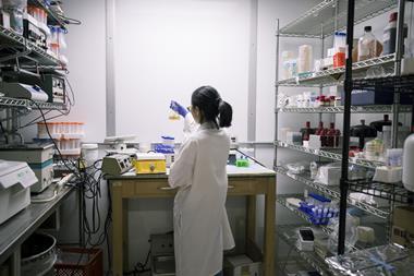A photo of a young woman working in a laboratory