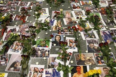 An image showing flowers seen placed on the portraits of the victims of flight PS 752 at the memorial corner of Boryspil International Airport