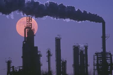 A photograph showing the silhouette of an oil refinery