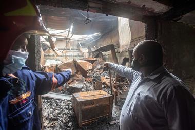 An image showing two men pointing at the aftermath of a chemical fire