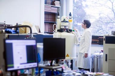 A Chemist using an NMR spectrometer in a lab