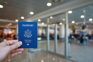 Someone holding an American passport at an airport