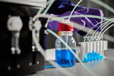 Laboratory photo showing a scientist working with Syris Atlas HD Syringe Pump lab bench equipment