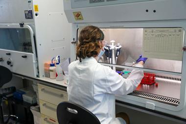 An image showing a scientist undergoing Covid research