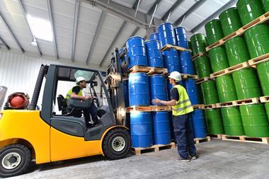 A picture showing a group of workers with forklift