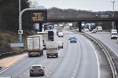 An image showing a motorway and a sign reading 'Freight to Eu new documents required'
