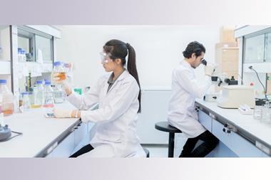A photo of a male and female scientist working in a generic lab environment