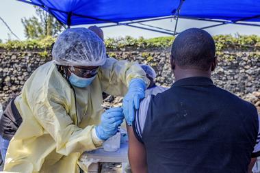 An image showing a man receiving a vaccine against Ebola