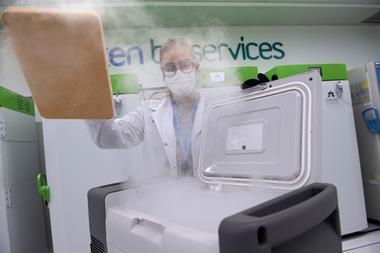 An image showing a woman operating an ultra low temperature freezer