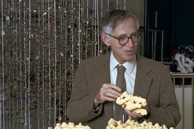 Aaron Klug photographed in the model room at LMB with one of his virus models, c. 1970s.