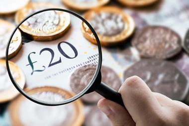 A picture showing a magnifying glass over British pound notes