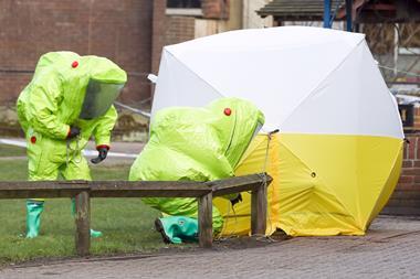 Investigators wearing hazmat suits whilst securing a tent for investigations into the Novichok poisonings