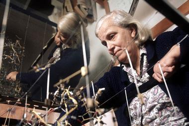 A photograph of Dorothy Hodgkin with a molecular model