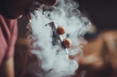 A picture showing an electronic cigarette being used