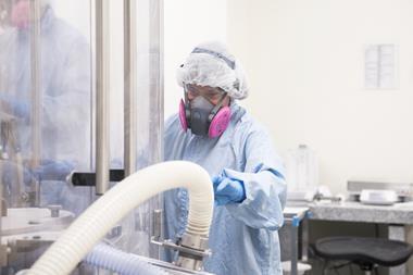 An image showing a worker in protective gear