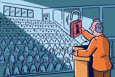 Lecturer holding up unlocked book