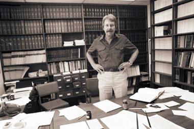 John Stille inventor of the still cross coupling standing in his office