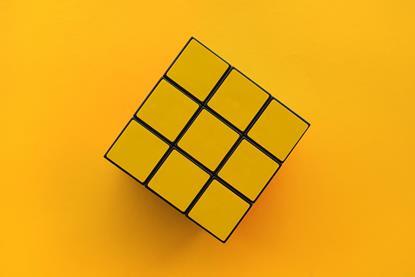 Yellow Rubik's cube on yellow background