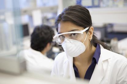 An image showing a scientist wearing spectacles and a face mask