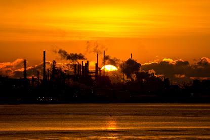 Sun rising over refinery
