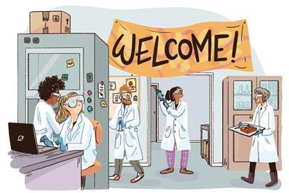 Group of people in a lab with a welcome sign above the door