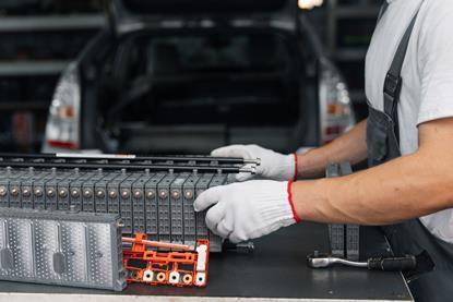 Serviceman repairs electric battery pack of hybrid car