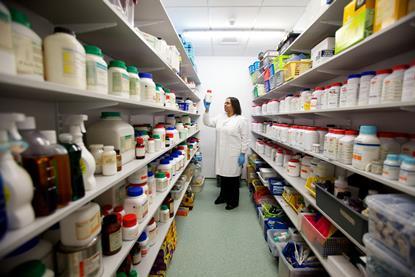 An image showing a technician examining chemicals