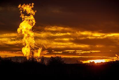Flames from a flaring pit near a well in the Bakken Oil Field - hero (flipped)